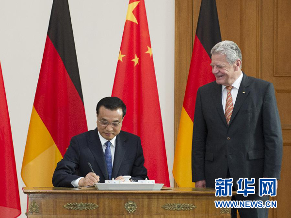 10月10日，國務院總理李克強在柏林會見德國總統高克。這是李克強總理在高克總統的陪同下在貴賓簿上簽字。 新華社記者 王曄 攝 