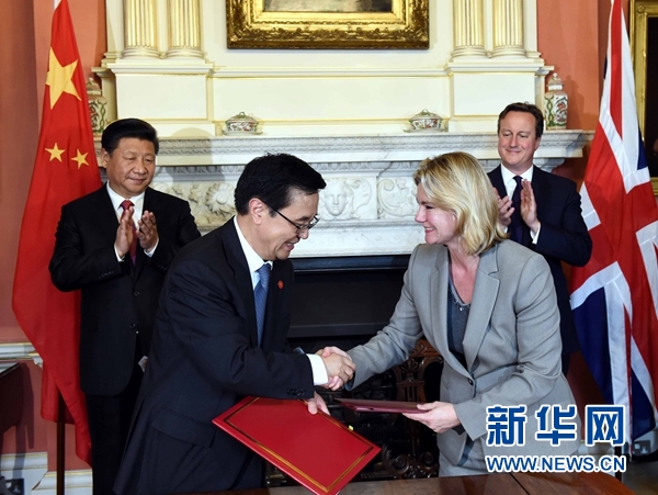 10月21日，國家主席習近平在倫敦唐寧街首相府同英國首相卡梅倫舉行會談。這是會談結束后，兩國領導人共同見證雙邊合作文件的簽署。新華社記者 饒愛民 攝 